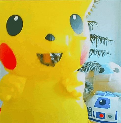a pikachu costume is standing next to a r2d2 costume