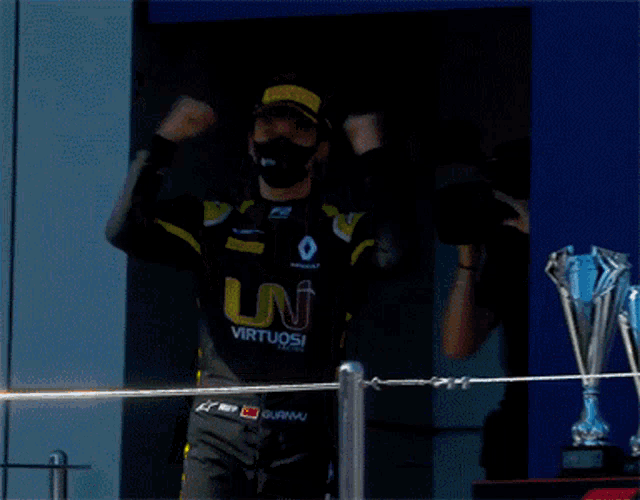 a man wearing a black and yellow outfit with virtuosi written on it