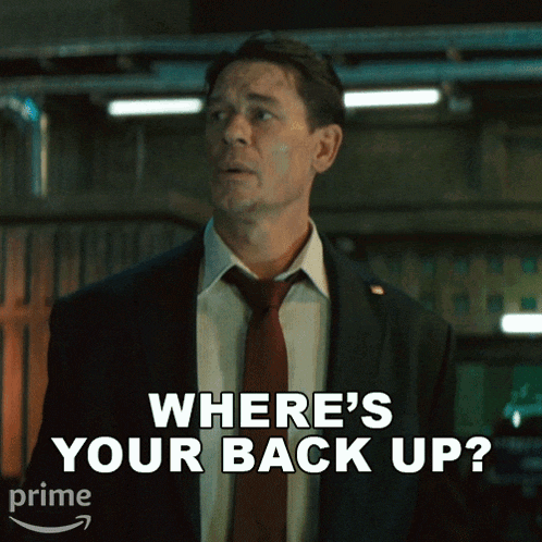 a man in a suit and tie asking where 's your back up