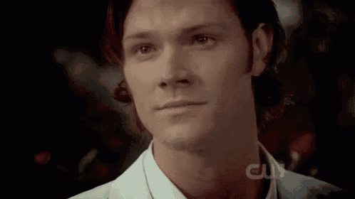 a close up of a man 's face with the words cw on the bottom