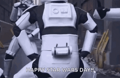 a stormtrooper is kneeling down in front of another stormtrooper .