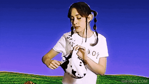 a girl wearing a white shirt that says doy