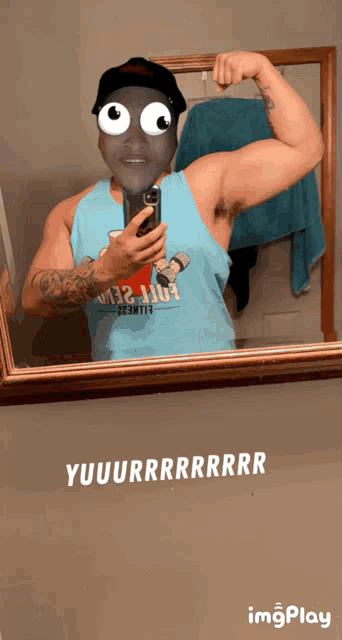a man taking a selfie in front of a mirror with yuuuurrrrrrrrr written on the wall
