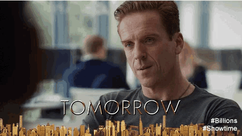 a man is sitting in front of a sign that says " tomorrow "