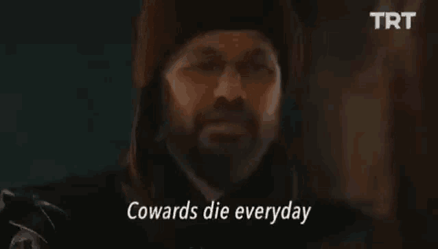 a man with a beard and glasses is talking about brave men die only once