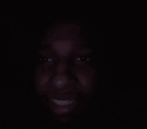 a close up of a person 's face in the dark .