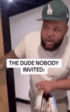 a man wearing a la hat is holding a bag of food and a sign that says the dude nobody invited .