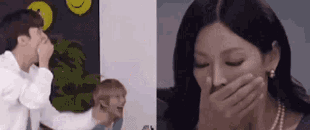 a man and a woman are laughing together and the woman is covering her mouth .