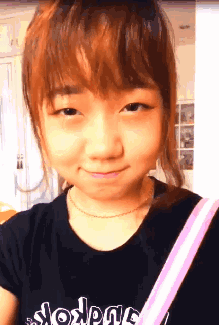 a young girl wearing a black shirt that says slogan
