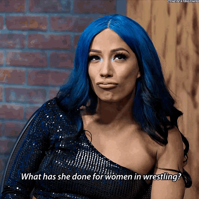 a woman with blue hair asks " what has she done for women in wrestling "