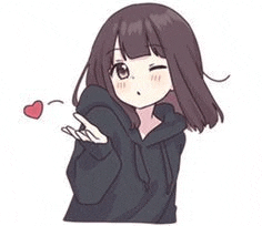 a girl in a black hoodie is blowing a kiss and holding a heart .