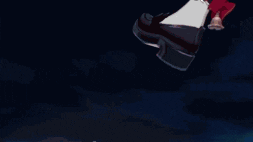a person 's foot with a red bow on it is standing on a blue bubble .