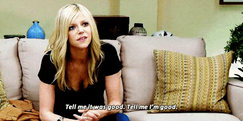 a woman sits on a couch and says tell me it was good