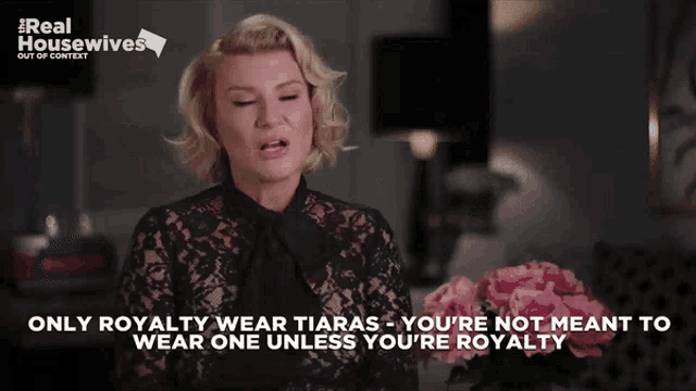 a woman wearing a black lace top with the words " only royalty wear tiaras " on the bottom