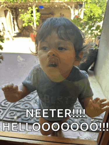 a baby in a blue shirt says neeter hello
