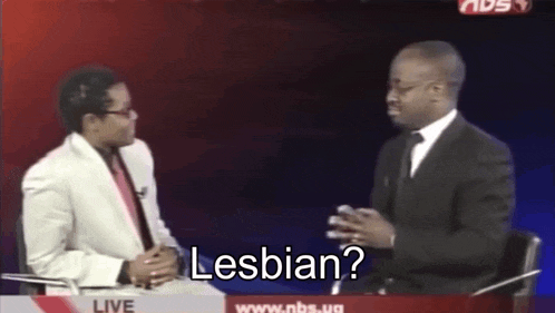 two men are sitting in front of a sign that says ' homosexual '