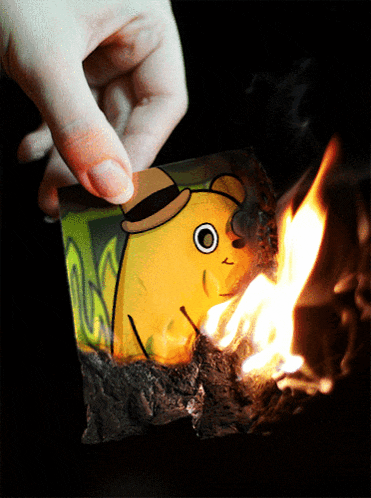 a person is holding a piece of paper that has a yellow cartoon character on it