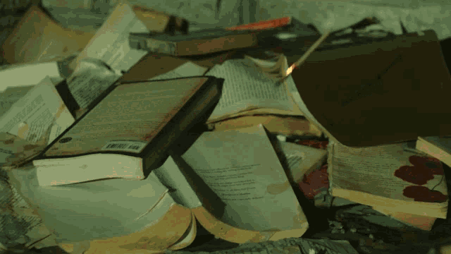 a pile of books are on fire and one of them has a barcode