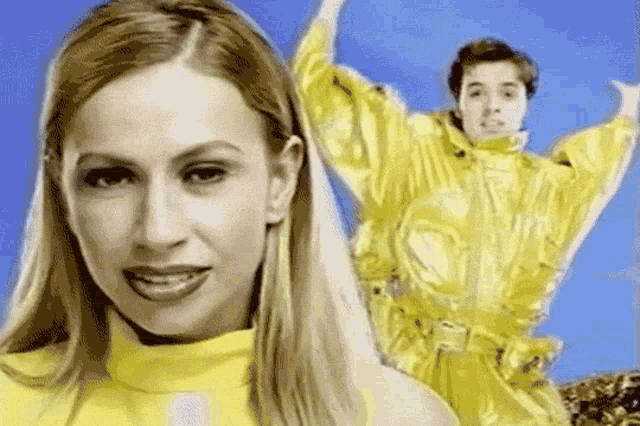 a woman in a yellow sweater is standing next to a man in a yellow jacket