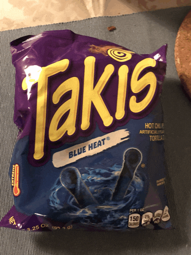 a bag of takis blue heat chips is sitting on a table