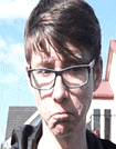 the man is wearing glasses and making a sad face .