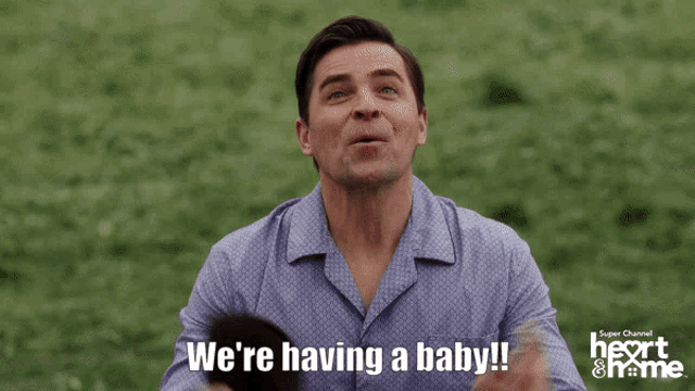 a woman looking out of a window with the words we 're having a baby below her