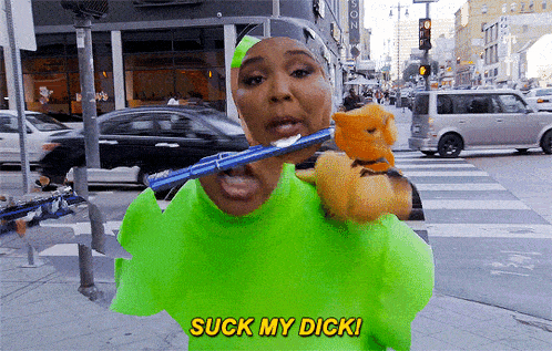 a woman in a neon green shirt is brushing her teeth