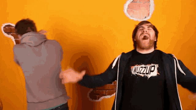 a man wearing a shirt that says wuzzup laughs