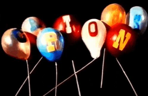 a bunch of colorful balloons on sticks with the letters r and o on them
