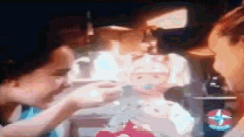 a blurry picture of a person holding a candle with a starbucks logo in the background
