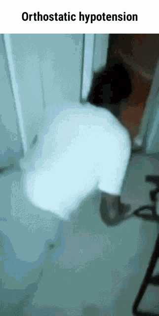 a man in a white shirt is standing in a doorway with the words orthostatic hypotension above him