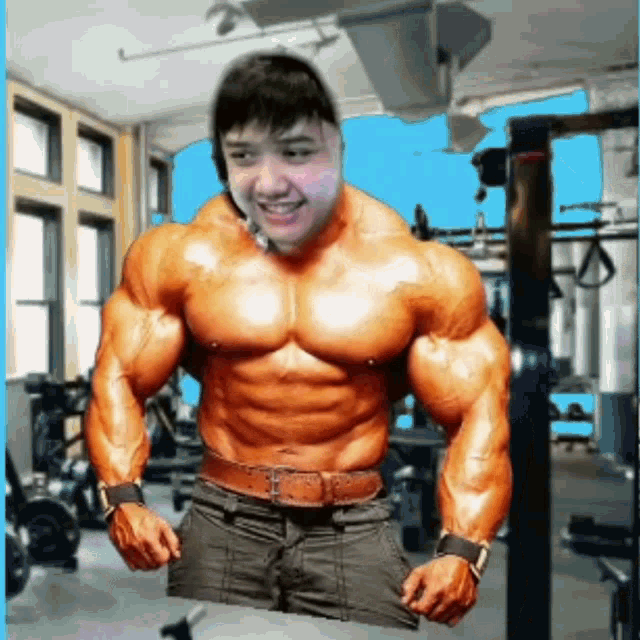 a very muscular man is standing in a gym