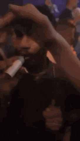 a blurry picture of a person holding a bottle of something