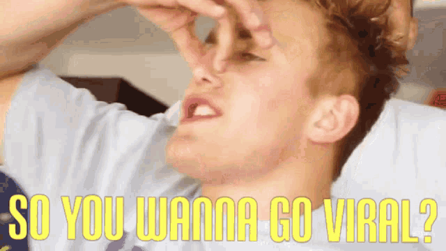 a man covering his nose with his hand and the words " so you wanna go viral " below him