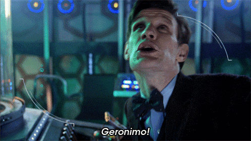 a man in a suit says geronimo in a dark room