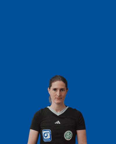 a female referee holds up a digital clock that reads 8:33