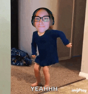 a little girl wearing headphones and glasses is dancing and says yeahh