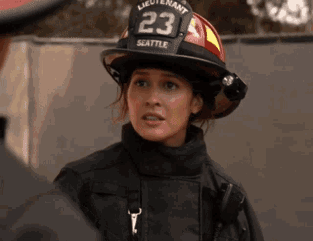 a female firefighter wearing a helmet with the number 23 on it