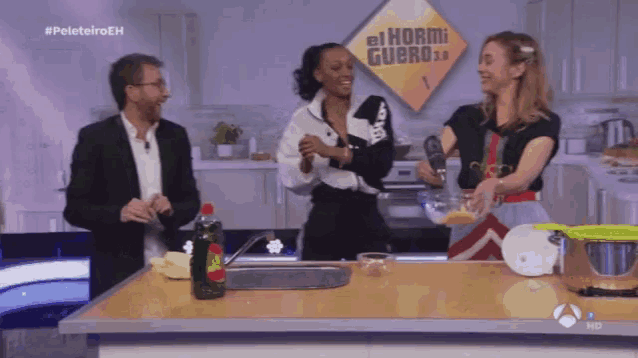 a group of people standing in front of a sign that says el hormiguero