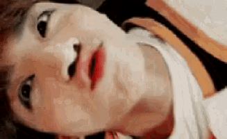 a close up of a person 's face with their mouth open and their eyes closed .