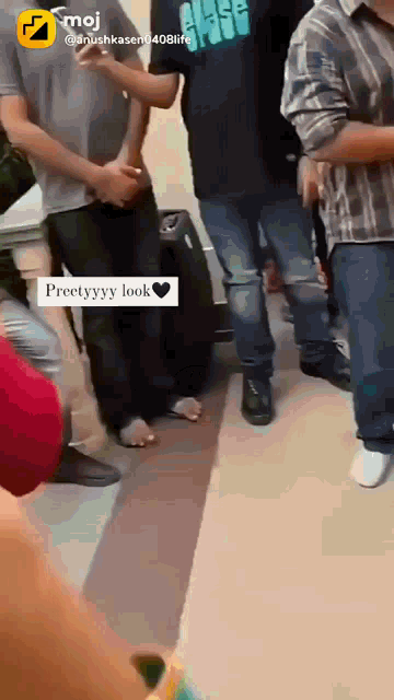 a group of people are standing in a hallway and one of them is wearing a shirt that says ' class ' on it