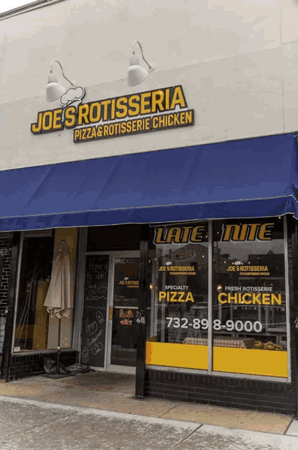 joe 's rotisserie pizza and rotisserie chicken has a large blue awning