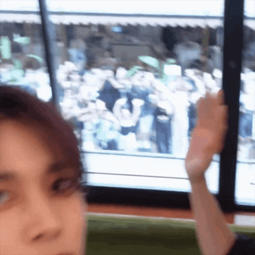 a blurry picture of a person 's face with a crowd behind them