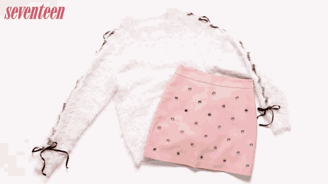a sweater a skirt and a clutch with the word love written on it