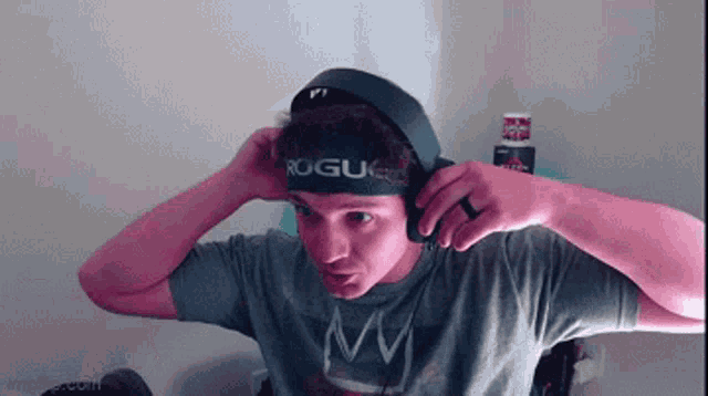 a man wearing headphones and a headband with the word rogue on it