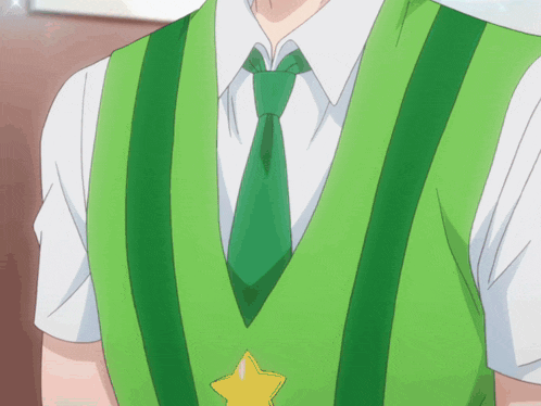 a man wearing a green vest and tie with a yellow star on it
