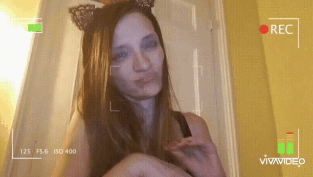 a woman wearing cat ears is being recorded on a vivavideo