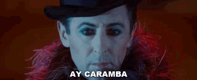 a man with feathers around his neck and the words ay caramba on the bottom