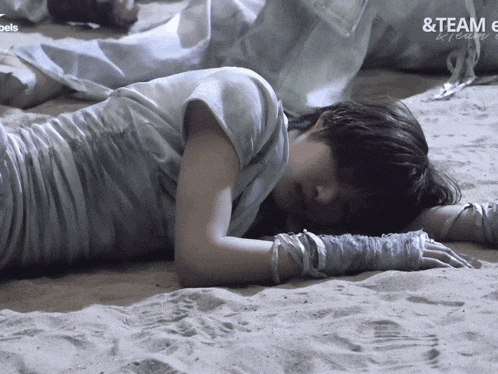 a person laying on a sandy surface with the words & team e on the bottom