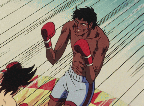 a man in boxing gloves is standing in front of another man
